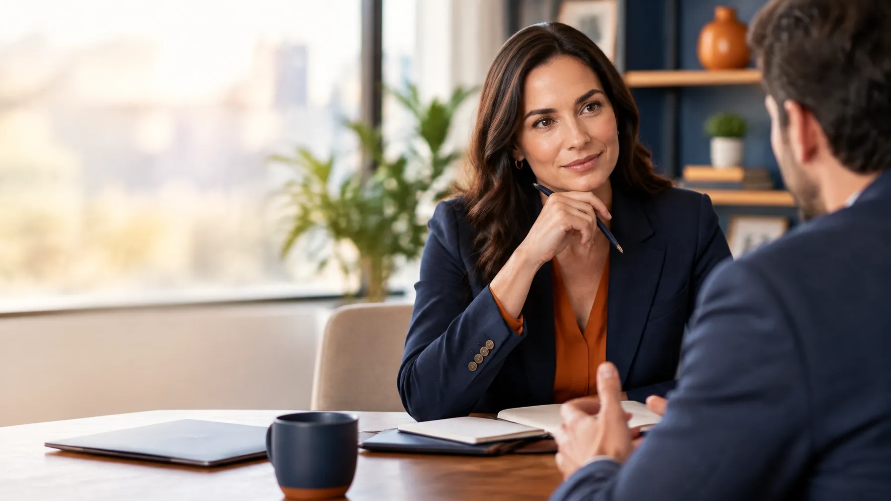 Financial advisor listening carefully to a founder across a quiet meeting table