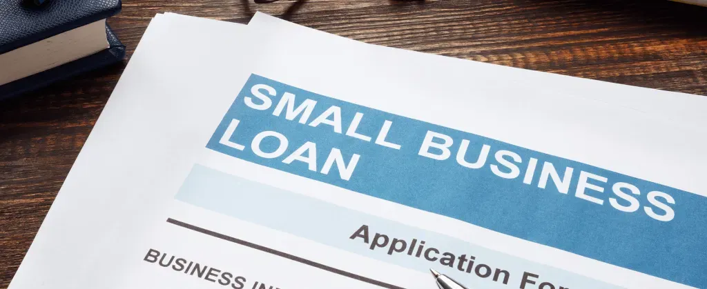 Small business loan application on a desk representing a defined expansion funding plan