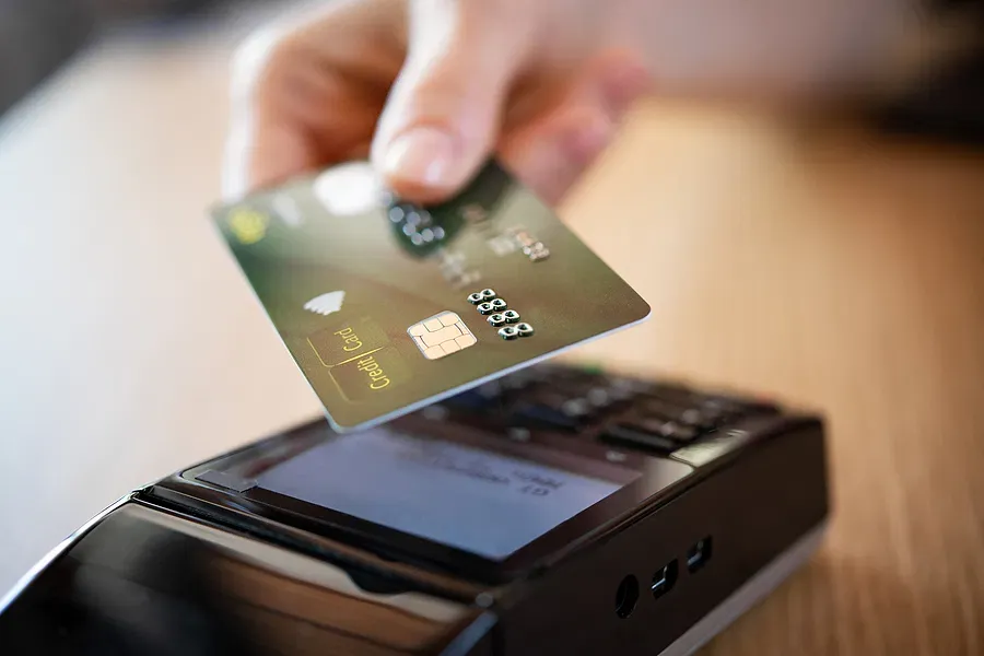 Customer using a contactless payment terminal for business card processing