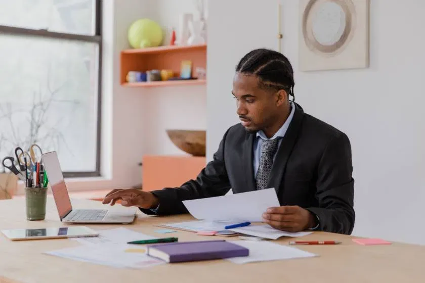 Consultant analyzing business documents for financial planning and a practical growth strategy